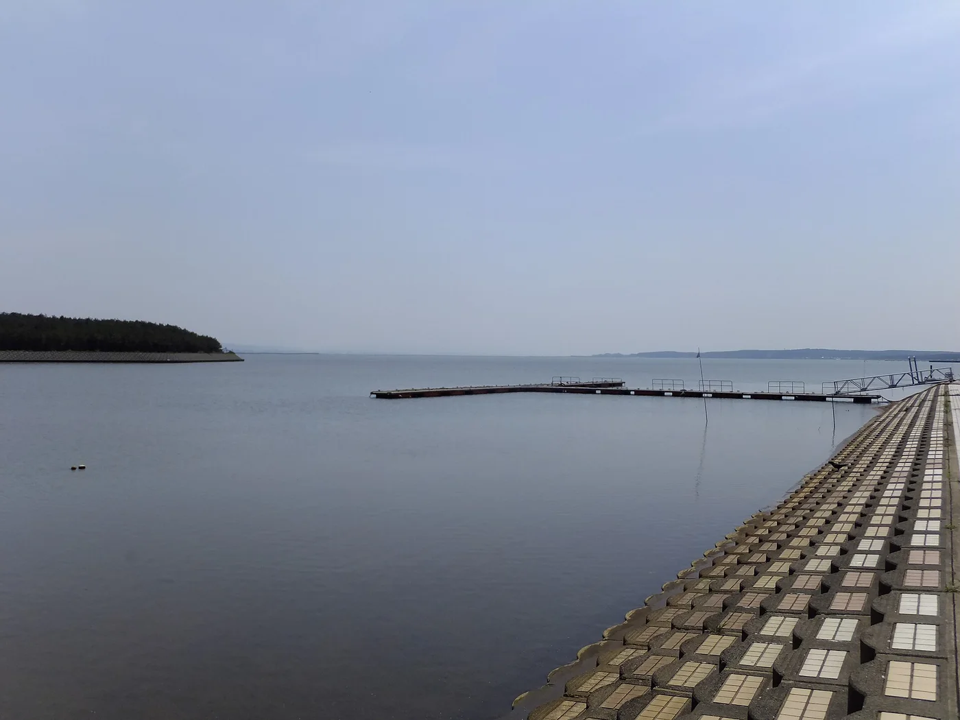 十三湖の湖面。広い水面の向こうに低い岸が続き、空が大きく広がっている