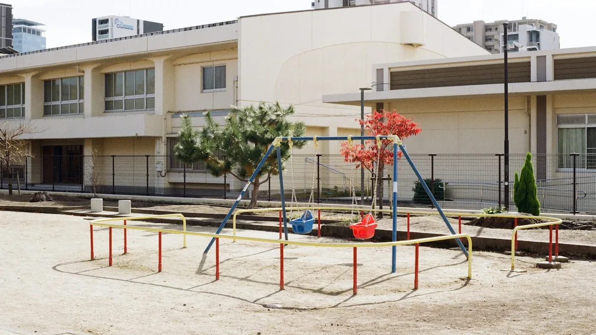 園庭のブランコと、その向こうに建つ園舎