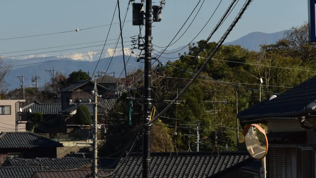 日本の住宅地。瓦屋根の家が隣り合って建ち、電柱とカーブミラーが立っている
